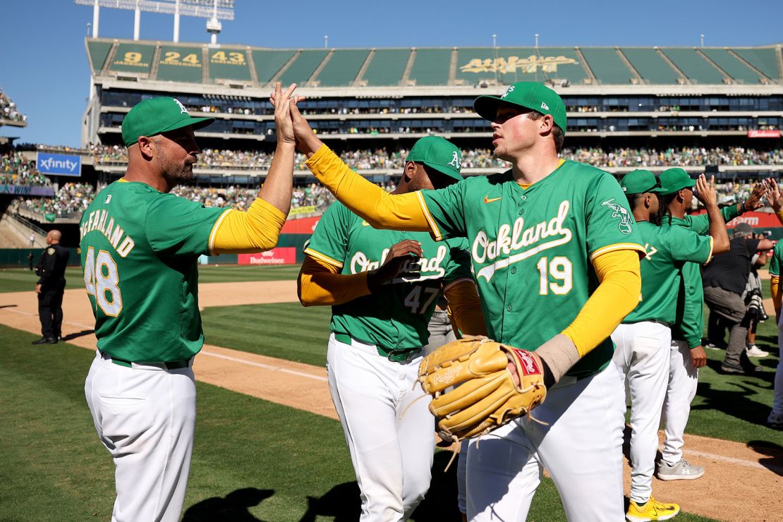 Athletics reserve player Mason Miller (No. 19) and his teammates celebrate the last home win in Oakland.