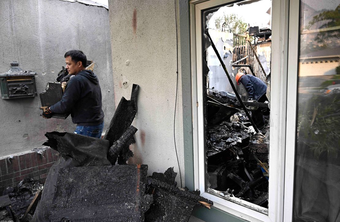 Benhard Dimalanta cleans out their family home destroyed in the Eaton Fire on January 9.