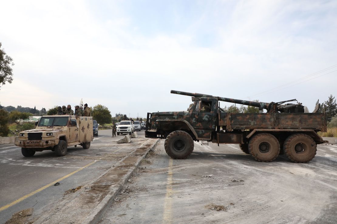 Syrian military vehicles block a road between Tartus and Latakia, Syria, on Friday.