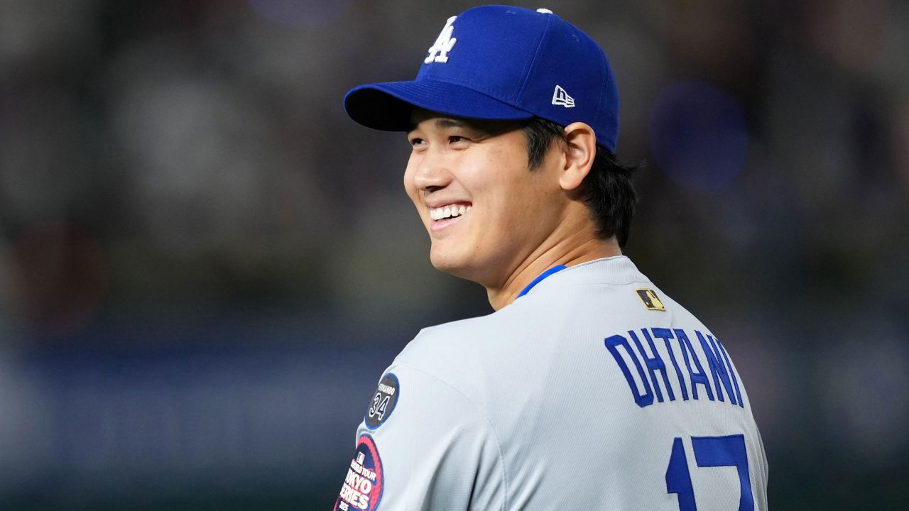 Ohtani smiles before the Dodgers' game against the Cubs in Tokyo.<br />Masterpress/Getty Images