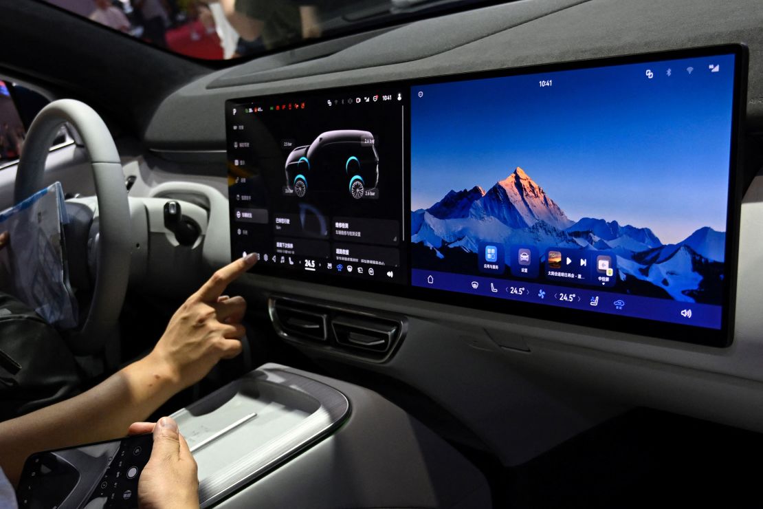 A man checks out the dashboard screen in Changan's Deepal S09.