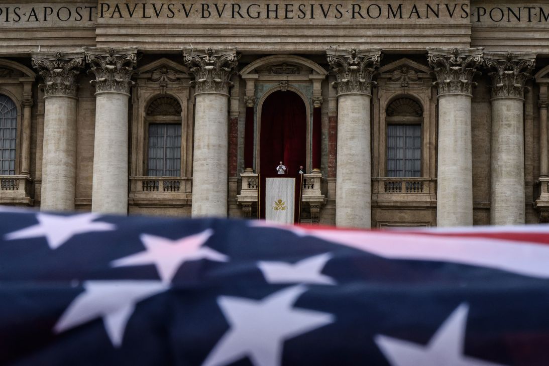 The American flag is waved over Pope Leo during the Regina Caeli prayer in the central loggia of St. Peter's Basilica in May.