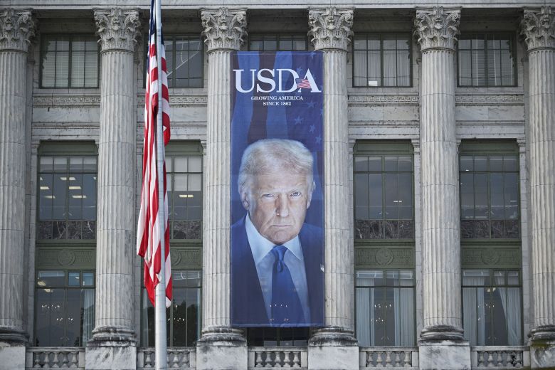A banner showing an image of President Donald Trump hangs on the side of a  Department of Agriculture building in Washington, DC, on May 16.