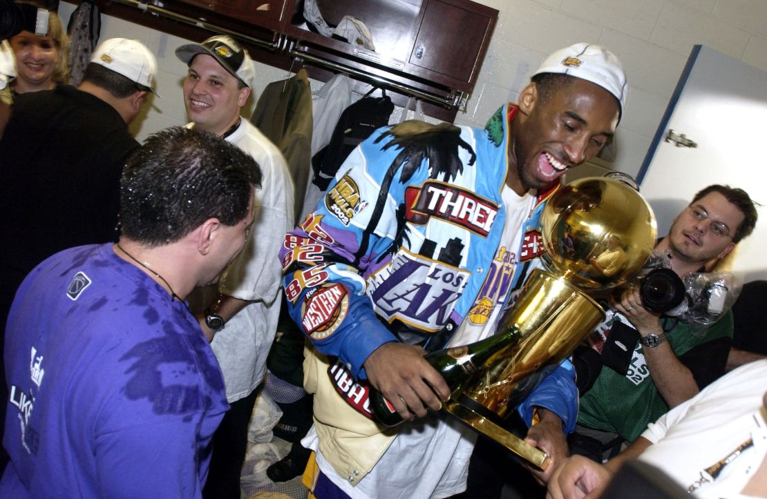 Bryant celebrates with the trophy after defeating the New Jersey Nets in the 2002 NBA Finals.