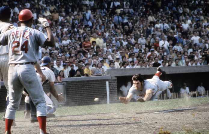 Rose's all-out effort earned him the nickname — first derisively, then admiringly — “Charlie Hustle." Here, he slides head first into home plate during a game against the Cubs in the late 1960s.