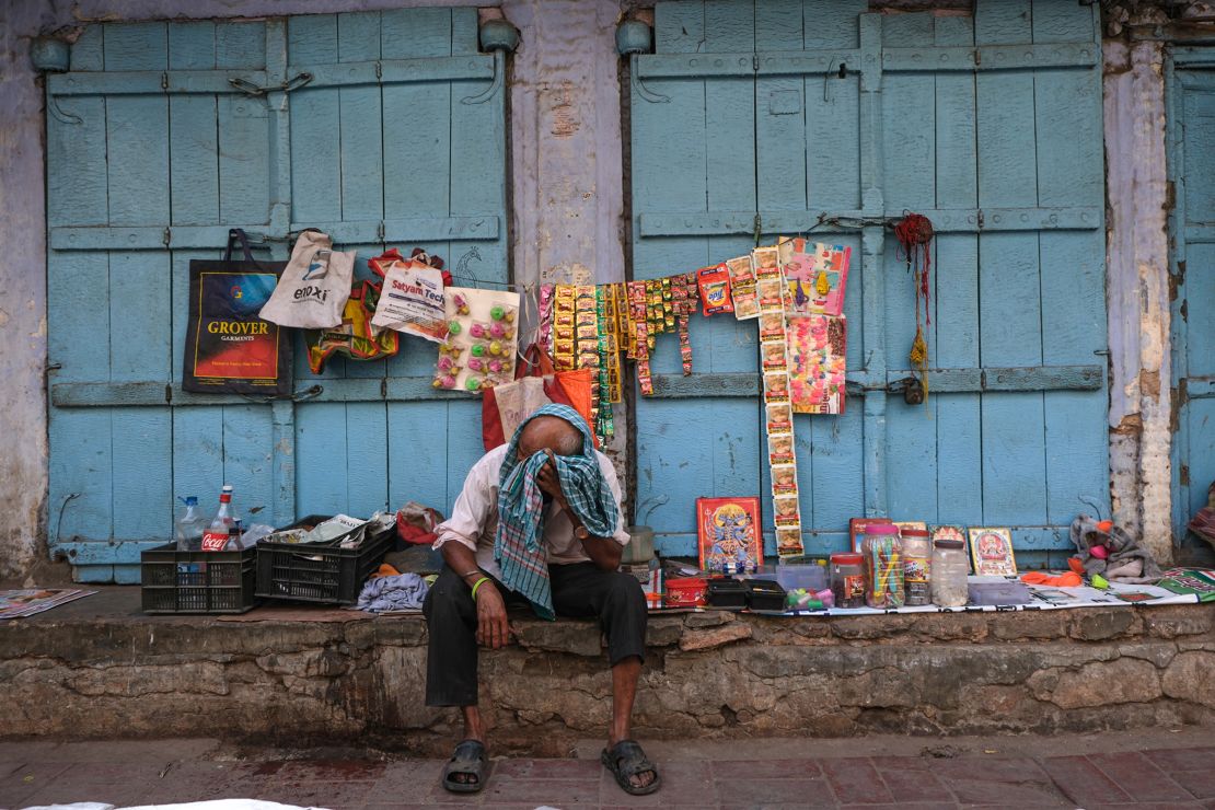 A man wipes his face during a hot day in New Delhi on April 21, 2024.