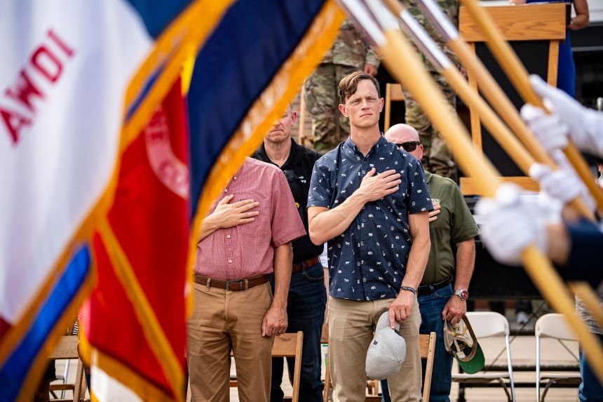 State Auditor and gubernatorial candidate Rob Sand stands for the national anthem during the Veterans Day Parade at the Iowa State Fair in Des Moines, Iowa, on August 11.