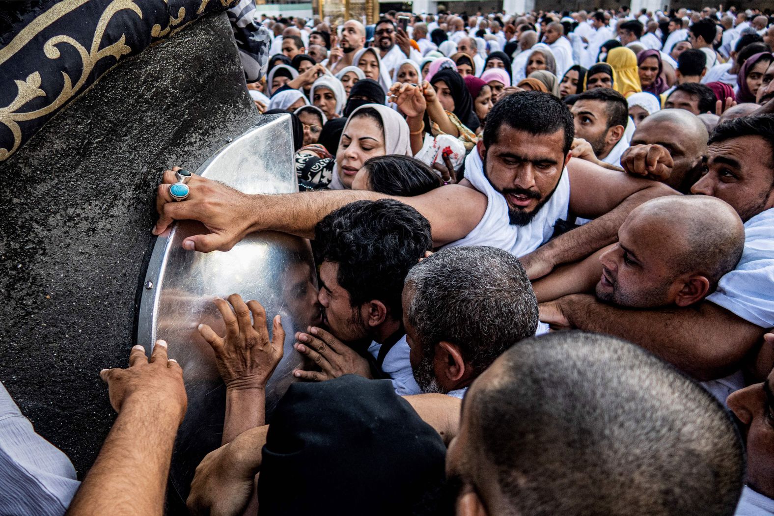 Muslim worshippers kiss and touch the Hajar al-Aswad ("Black Stone"), a rock set into the eastern corner of the Kaaba at the Grand Mosque in Mecca, Saudi Arabia, on Wednesday, September 6. The rock is believed to be the only piece remaining from an altar built by the patriarch Abraham.