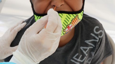 A boy receives a free Covid-19 test at a St. John’s Well Child & Family Center mobile clinic set up outside Walker Temple AME Church in South Los Angeles amid the coronavirus pandemic on July 15, in Los Angeles.