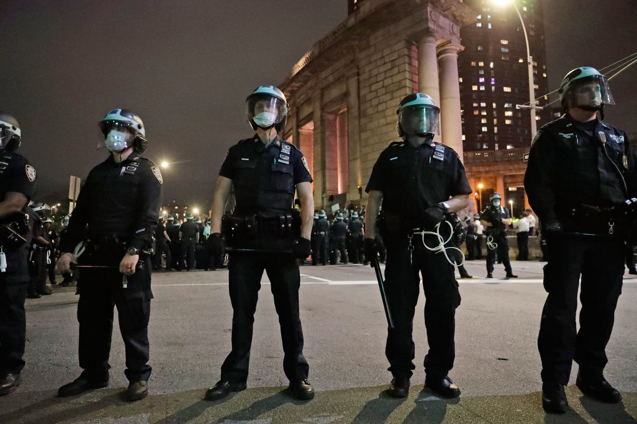 Police stand at the Manhattan Bridge on Tuesday night in New York.