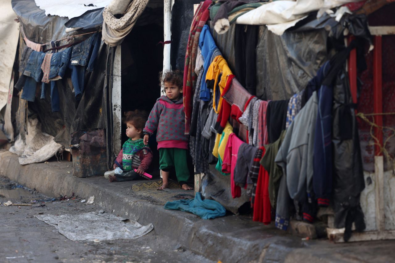 Children stand outside tents at a makeshift tent camp housing displaced Palestinians in Rafah, near the border with Egypt in southern Gaza, on January 23.