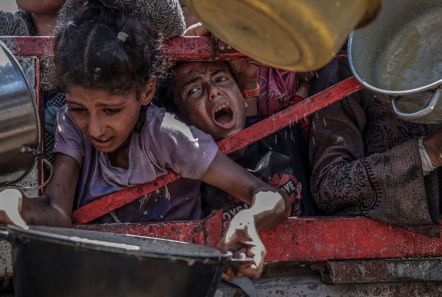 A charity organization distributed food to Palestinians facing severe difficulties accessing basic necessities due to Israel's ongoing blockade and military operations in the Gaza Strip on July 24, 2025. Crowds gathered during the distribution in Gaza City, highlighting the growing humanitarian crisis.