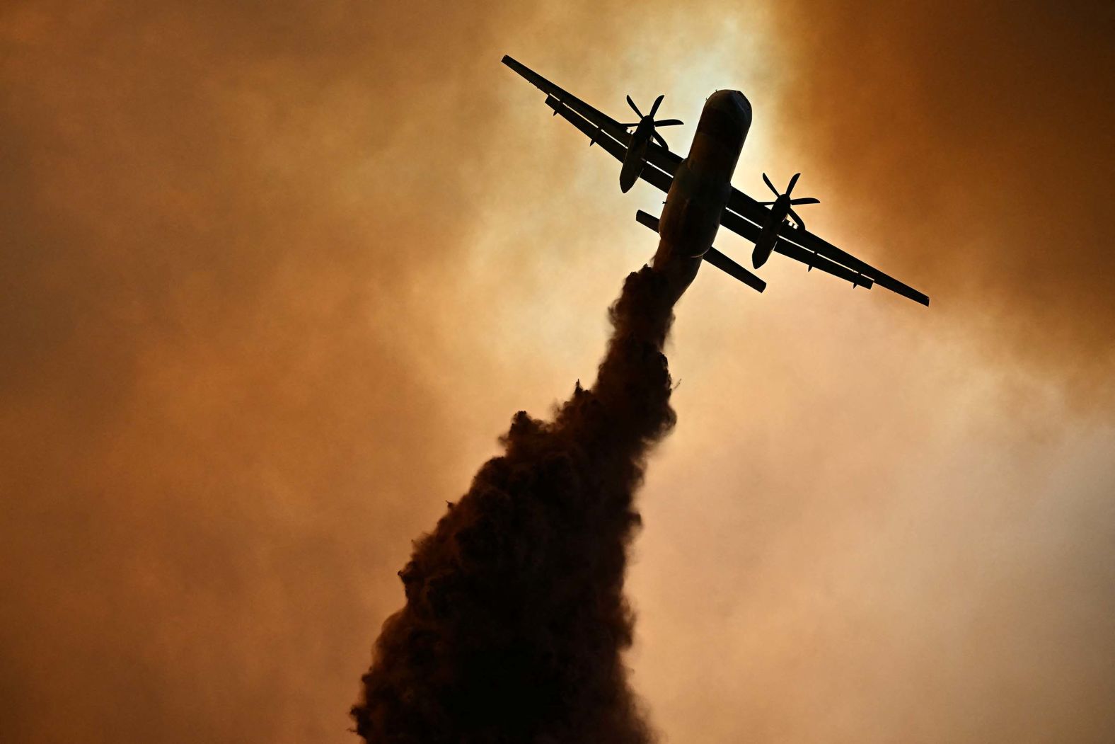 A plane drops fire retardant over a wildfire near Fontjoncouse, France, on Wednesday, August 6. The fire has now burned through 16,000 hectares – <a href="index.php?page=&url=https%3A%2F%2Fwww.cnn.com%2F2025%2F08%2F06%2Feurope%2Fsouthern-france-wildfire-woman-killed-intl">an area bigger than Paris</a> – but authorities say its advance has slowed significantly.