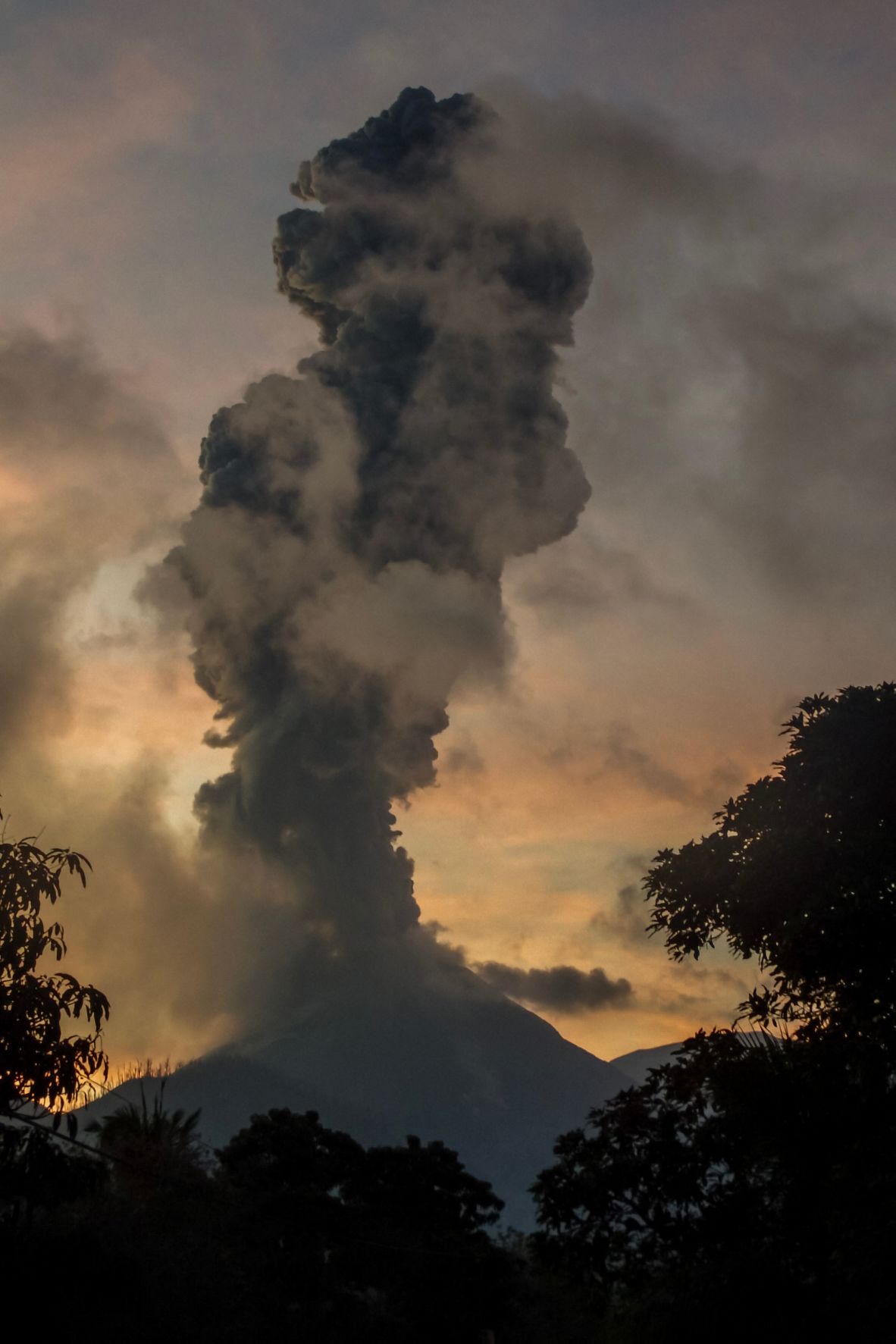 Mount Lewotobi Laki Laki, seen here from the Indonesian village of Boru, <a  target="_top" href="/newspapers?url=https://www.cnn.com/2025/07/07/asia/indonesia-mount-lewotobi-eruption-volcano-ash-cloud-intl">erupts</a> on Tuesday, July 8. It sent a column of volcanic materials as high as 18 kilometers (11 miles) into the sky.