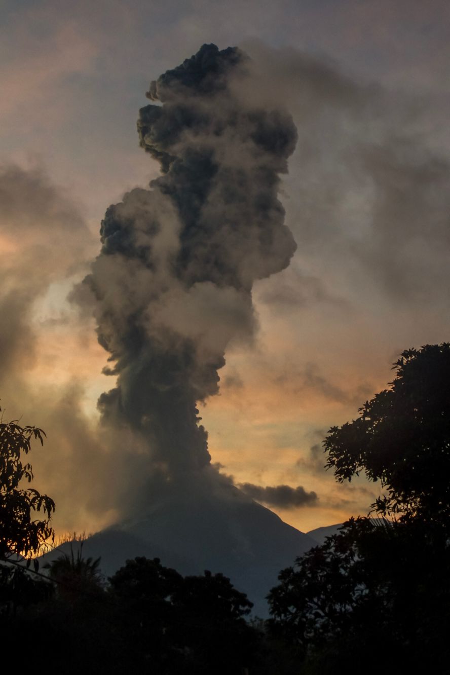 Mount Lewotobi Laki Laki, seen here from the Indonesian village of Boru, <a href="index.php?page=&url=https%3A%2F%2Fwww.cnn.com%2F2025%2F07%2F07%2Fasia%2Findonesia-mount-lewotobi-eruption-volcano-ash-cloud-intl">erupts</a> on Tuesday, July 8. It sent a column of volcanic materials as high as 18 kilometers (11 miles) into the sky.