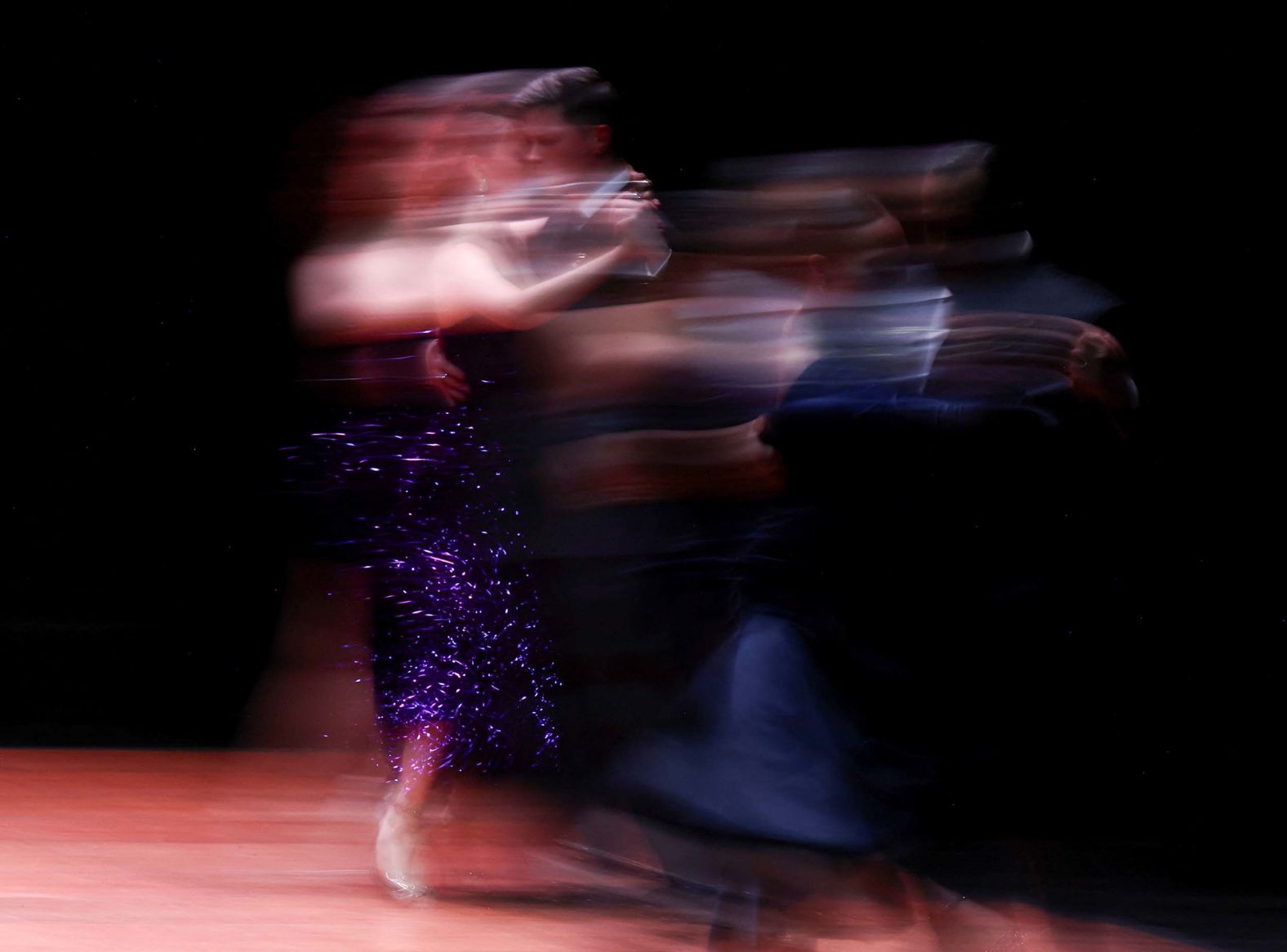 In this photo, taken with a slow shutter speed, dancers Erik Deslarmes and Nadia Aguilar compete at the Tango World Championship final in Buenos Aires on Monday, September 1.