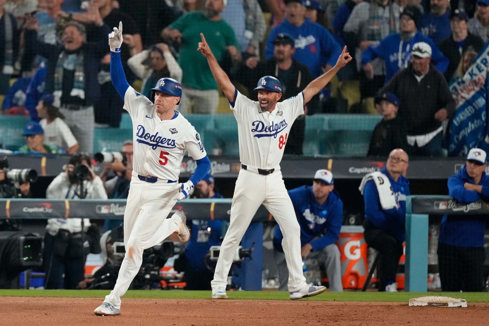 Los Angeles Dodgers first baseman Freddie Freeman, left, celebrates after hitting a home run <a href="index.php?page=&url=https%3A%2F%2Fwww.cnn.com%2F2025%2F10%2F28%2Fsport%2Fbaseball-mlb-blue-jays-dodgers-world-series-game-3">to win Game 3 of the World Series</a> on Monday, October 27. The home run came in the 18th inning and was the second-longest game in World Series history.