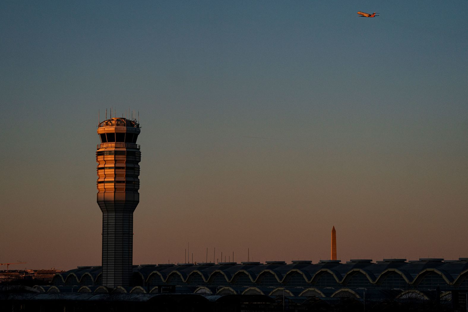 A plane takes off near the control tower at Reagan National Airport on Saturday, a few days after the tragedy.