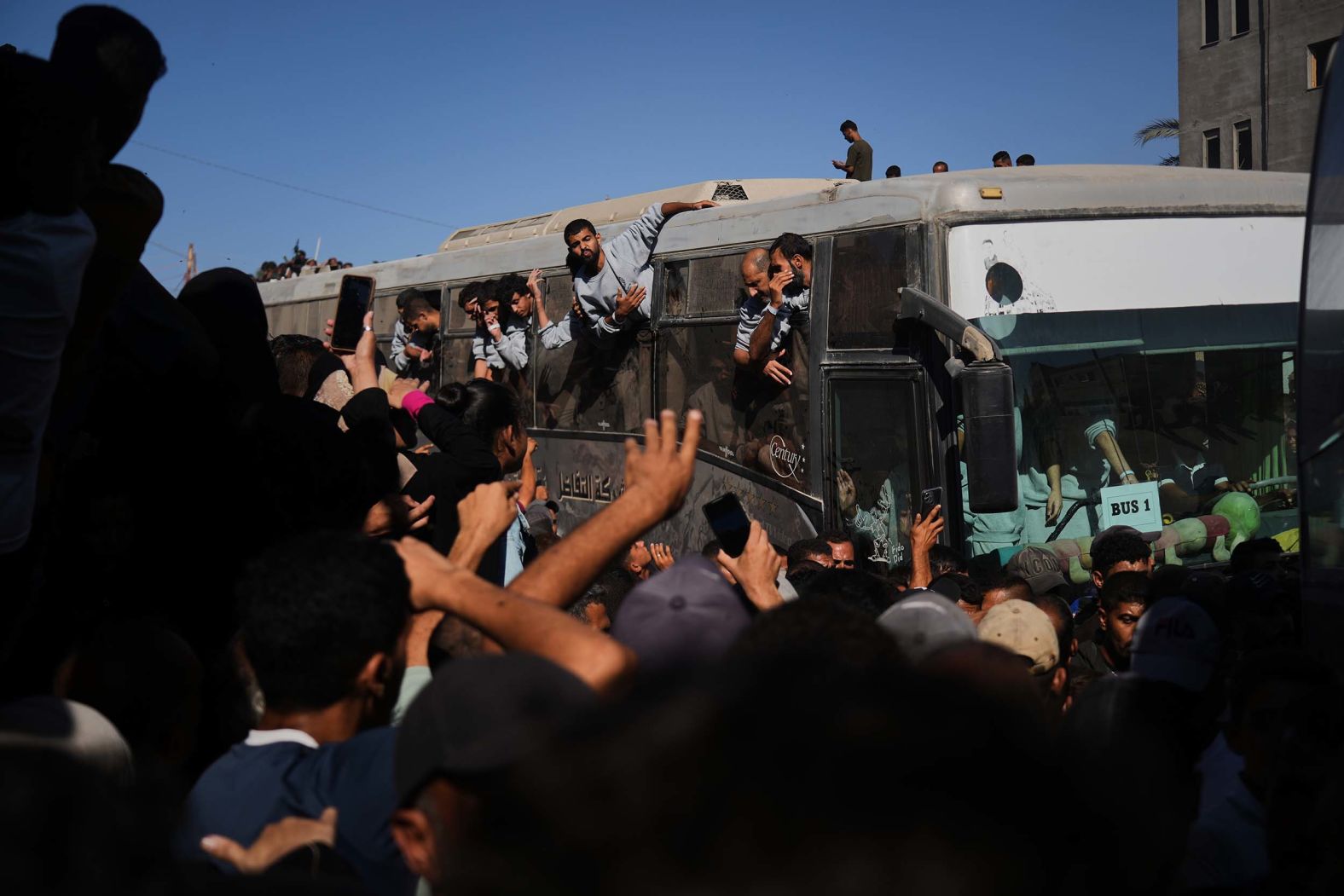 People gather outside of the Nasser Hospital in Khan Younis, Gaza, to greet Palestinian detainees who had been freed by Israel on Monday, October 13.