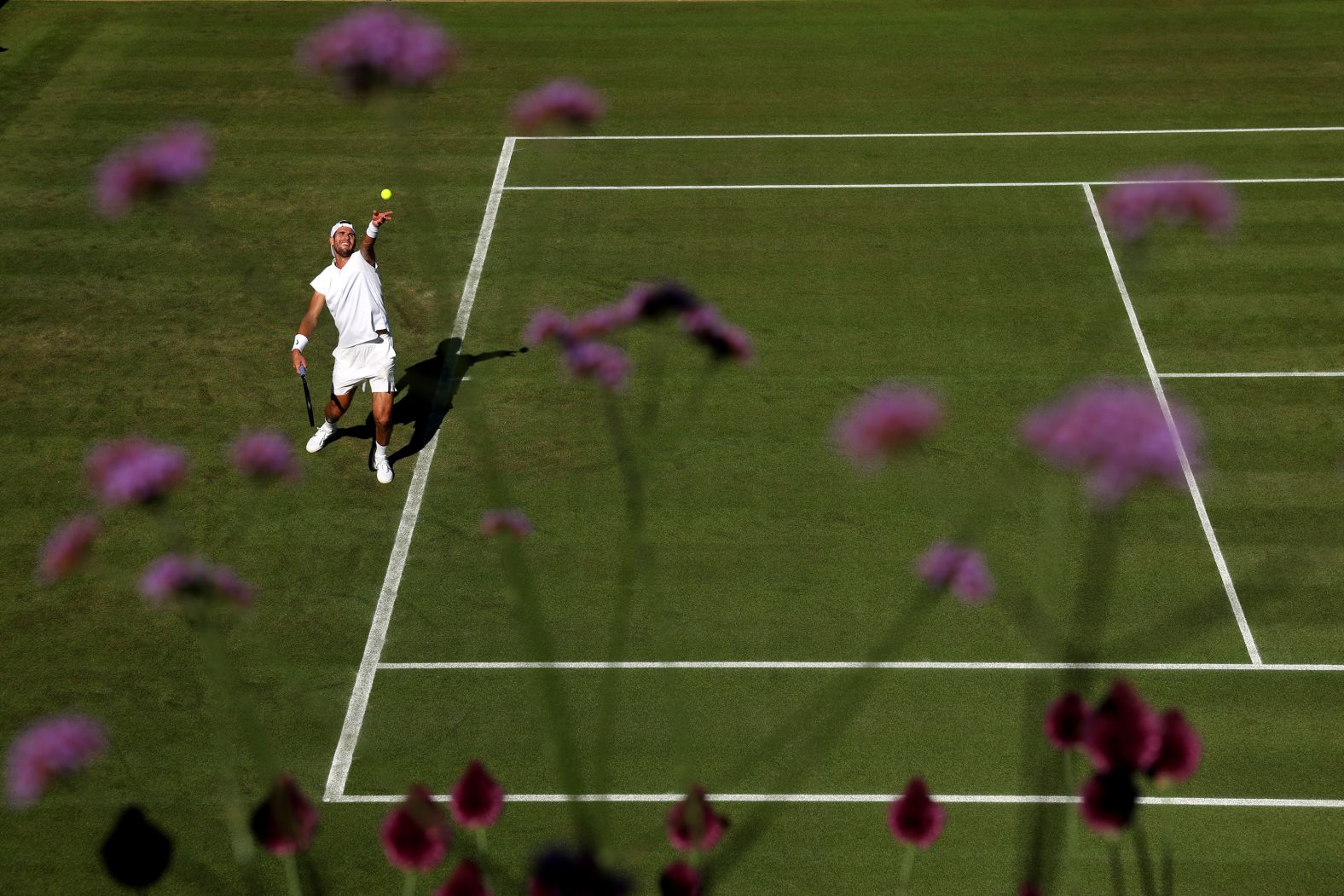 Karen Khachanov serves against Mackenzie McDonald during a first-round match at Wimbledon on Monday, June 30.