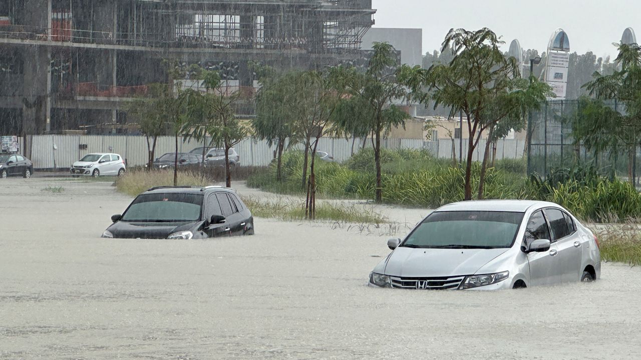 Floodwaters trap cars on a flooded street in Dubai, United Arab Emirates, Tuesday.