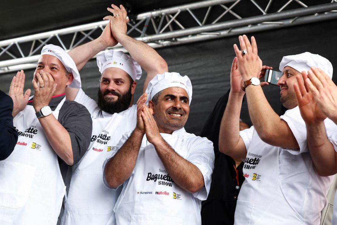 French bakers react after breaking the record for the longest bagette in the world measuring 140.53 meters long.