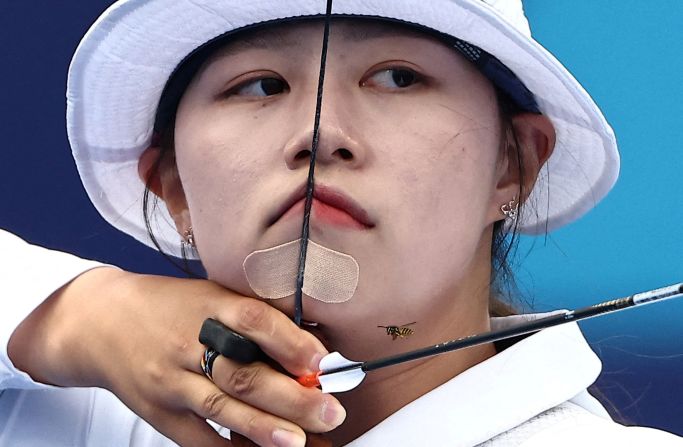 A bee flies near South Korean archer Lim Si-hyeon on August 3. <a >She won the individual event</a> for her third gold medal in Paris.