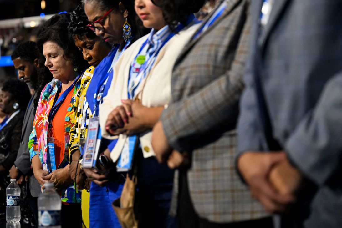 Delegates pray during first day of the Democratic National Convention  in Chicago, Illinois, on August 19.