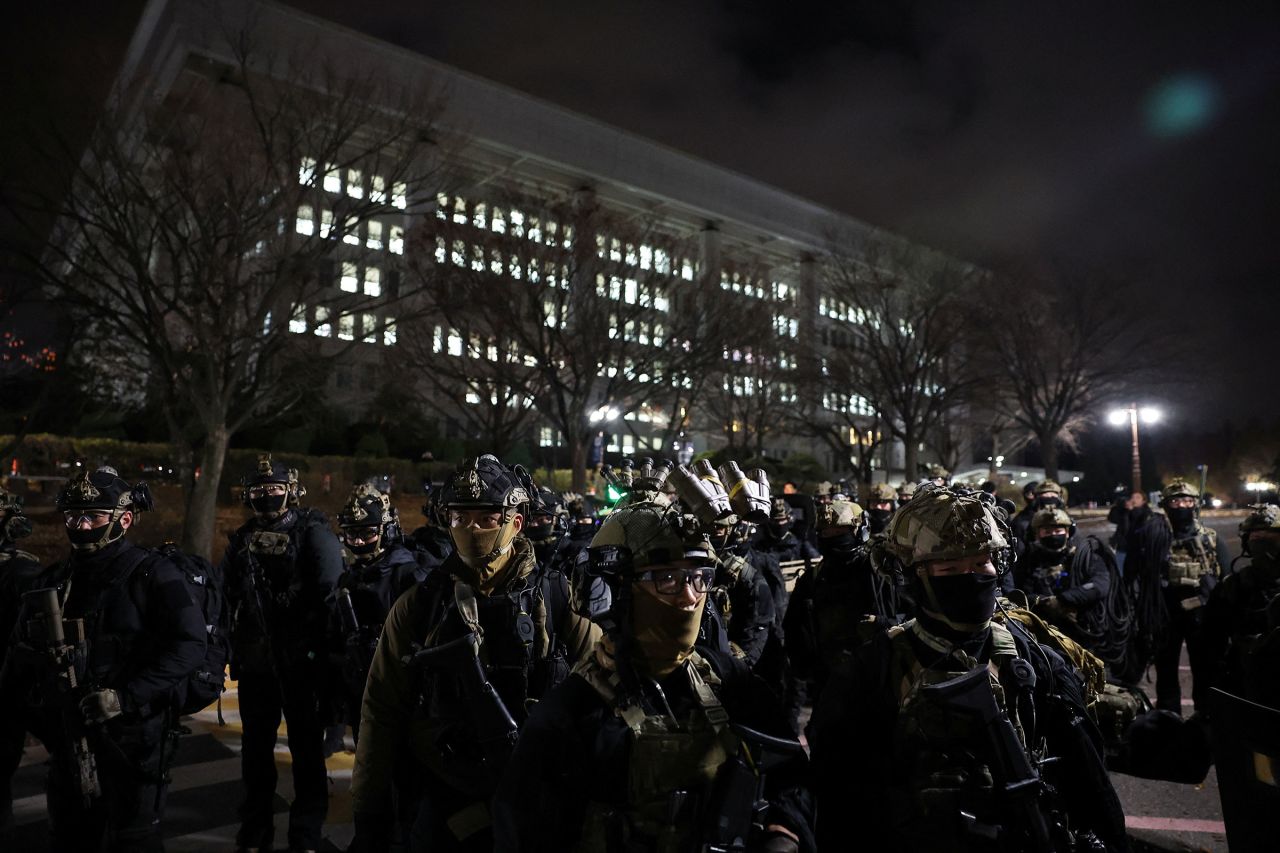 Members of the military stand outside the National Assembly.