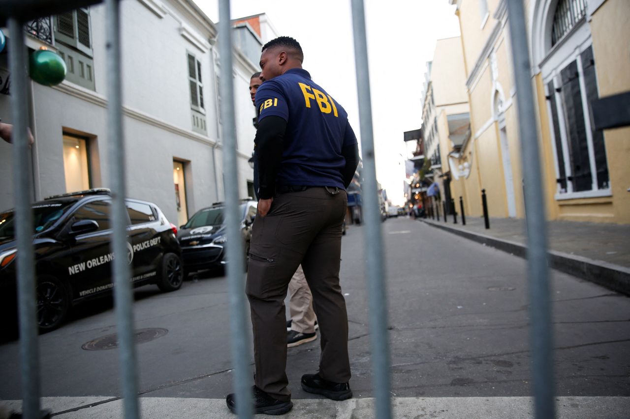 An FBI agent stands behind a security barrier near the site of the attack in New Orleans on January 1.