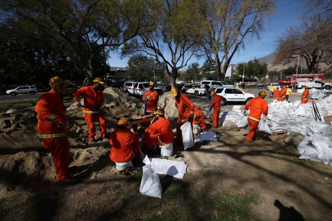 Inmates from the Fenner Canyon Conservation Camp Fire Crew help load sandbags in Pasadena. There is an increased threat of landslides in Los Angeles County, where the <a href="index.php?page=&url=https%3A%2F%2Fwww.cnn.com%2F2025%2F01%2F23%2Fus%2Fhughes-fire-los-angeles-county-thursday%2Findex.html">recent wildfires have charred much of the land</a> and left it with a lower capability of handling rain.