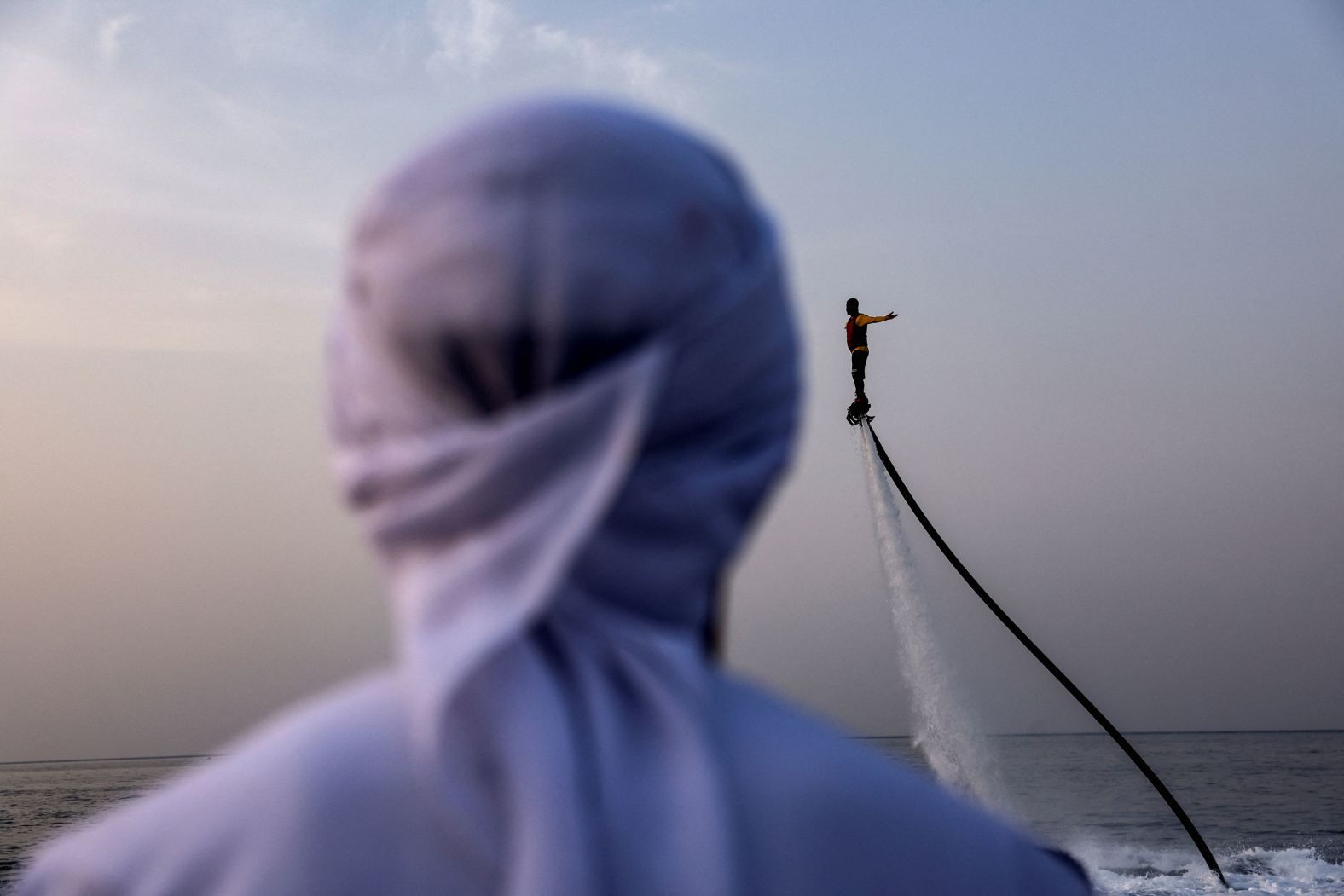 A man ascends on a flyboard during a water show in Musandam, Oman, on Wednesday, August 27.