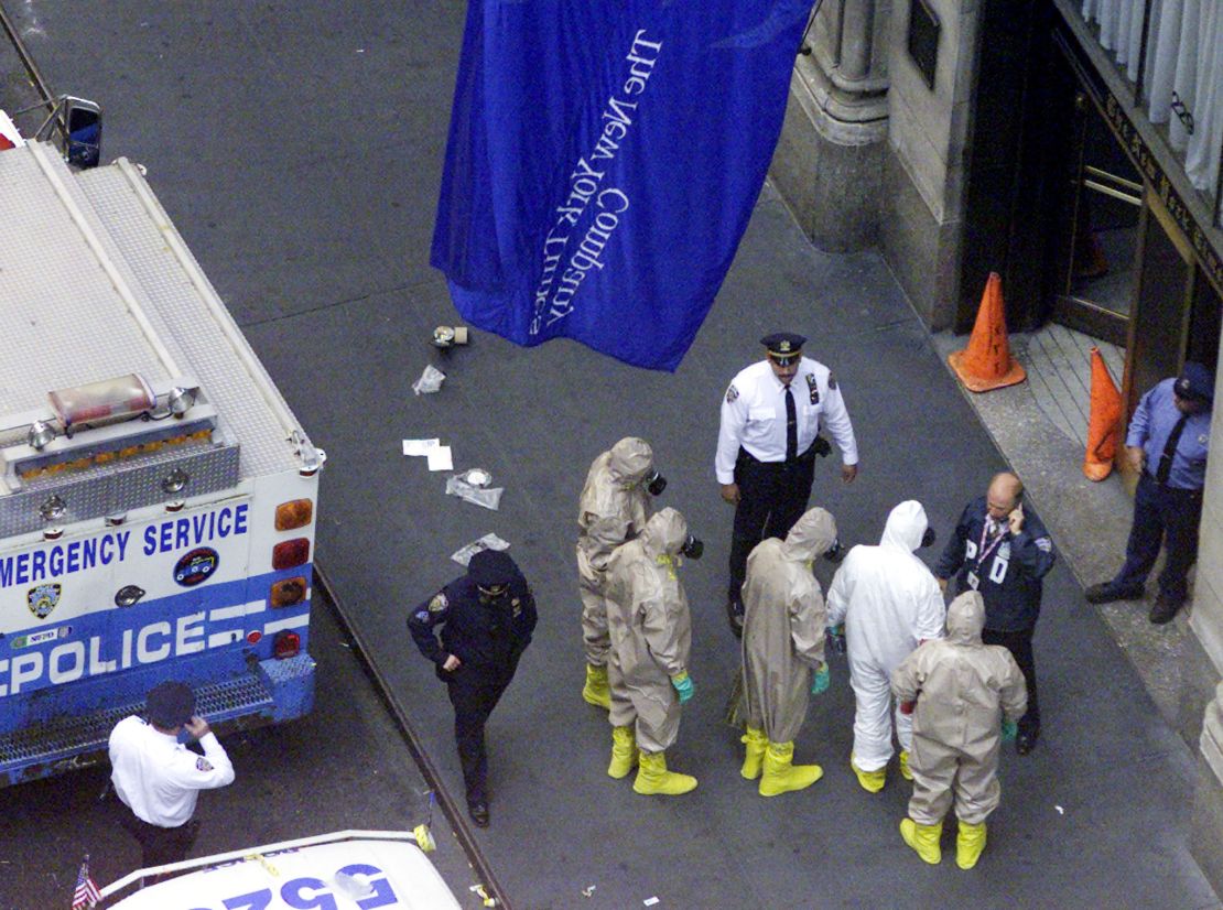 Investigators in protective suits prepare to enter the New York Times building in New York on October 12, 2001.