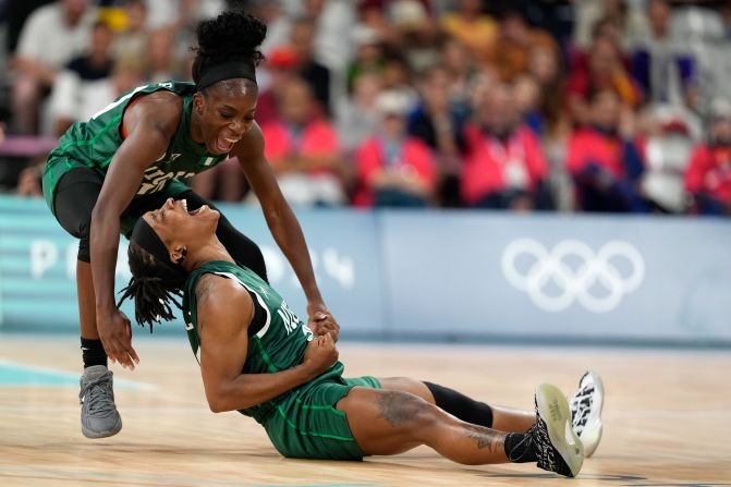 Nigerian basketball players Promise Amukamara, left, and Ezinne Kalu celebrate during their game against Canada on August 4. With a 79-70 win, <a >Nigeria made history</a> by becoming the first African team — men’s or women’s — to reach the quarterfinal stage of the Olympics.