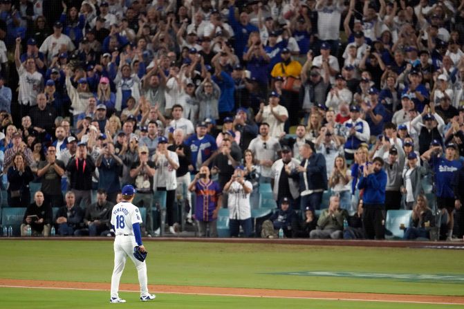 Fans cheer as Los Angeles Dodgers starting pitcher Yoshinobu Yamamoto leaves the game during the seventh inning of Game 2.