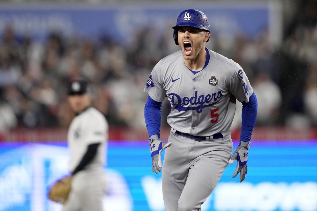 The Los Angeles Dodgers' Freddie Freeman celebrates his two-run home run against the New York Yankees during the first inning in Game 4.