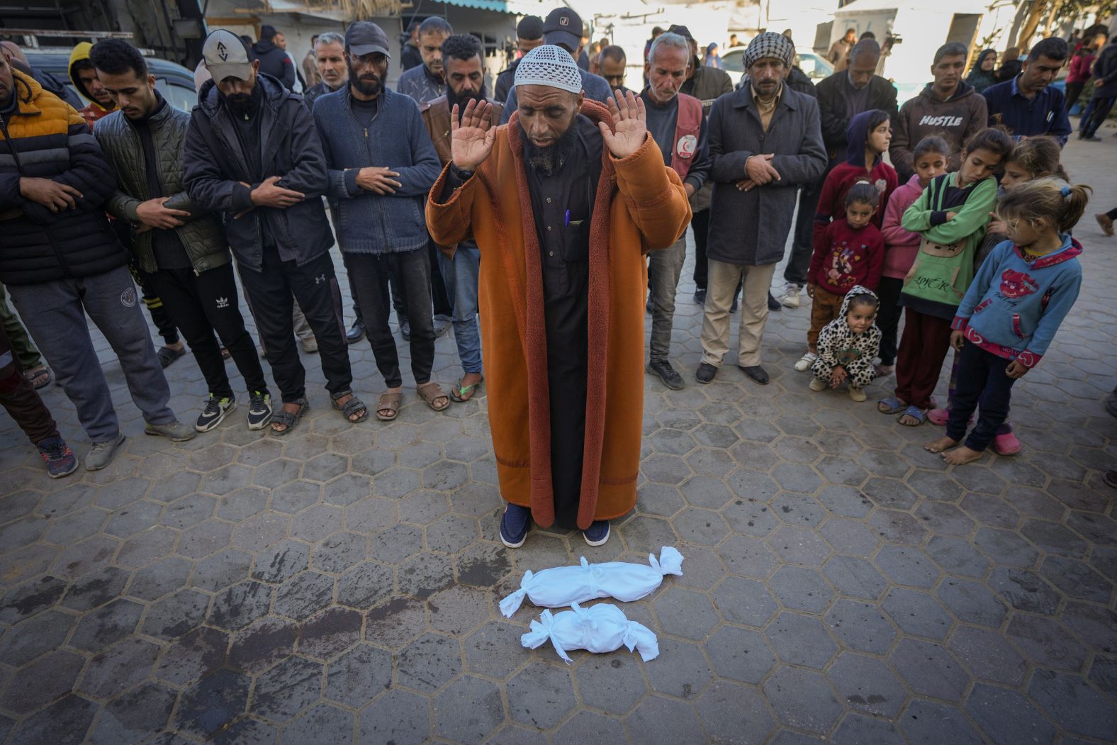 Imam Islam Abu Suaied prays over the bodies of two babies before their burial at the Al-Aqsa Martyrs Hospital in Deir Al-Balah, Gaza, on Sunday, December 29. One of the babies died at birth, while the other died of hypothermia. Several Palestinians, including at least five infants, have died in recent days <a href="index.php?page=&url=https%3A%2F%2Fwww.cnn.com%2F2024%2F12%2F31%2Fmiddleeast%2Fgaza-winter-palestinians-intl-latam%2Findex.html">due to severe cold weather</a>. The UN’s agency for Palestinian refugees warned on Tuesday that “more babies will likely die” in the coming days.