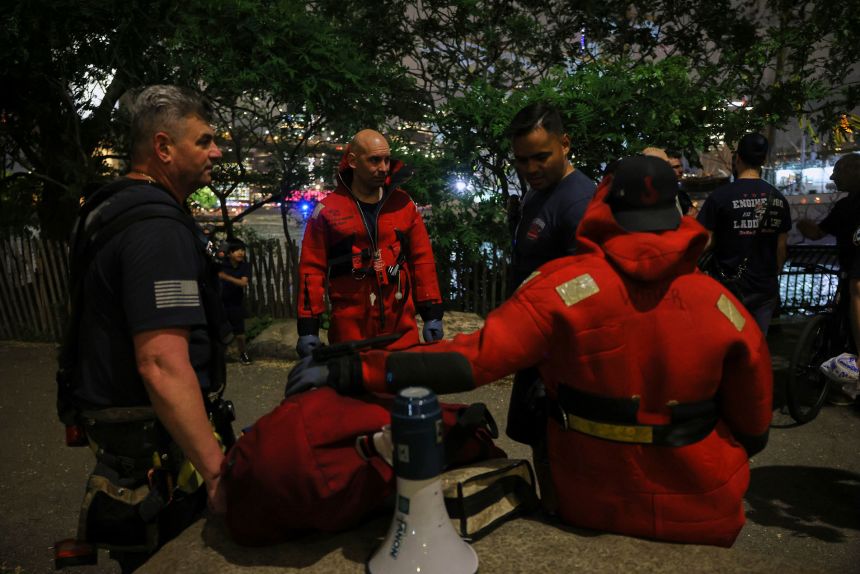 New York Fire Department divers prepare to dive the East River following the collision.