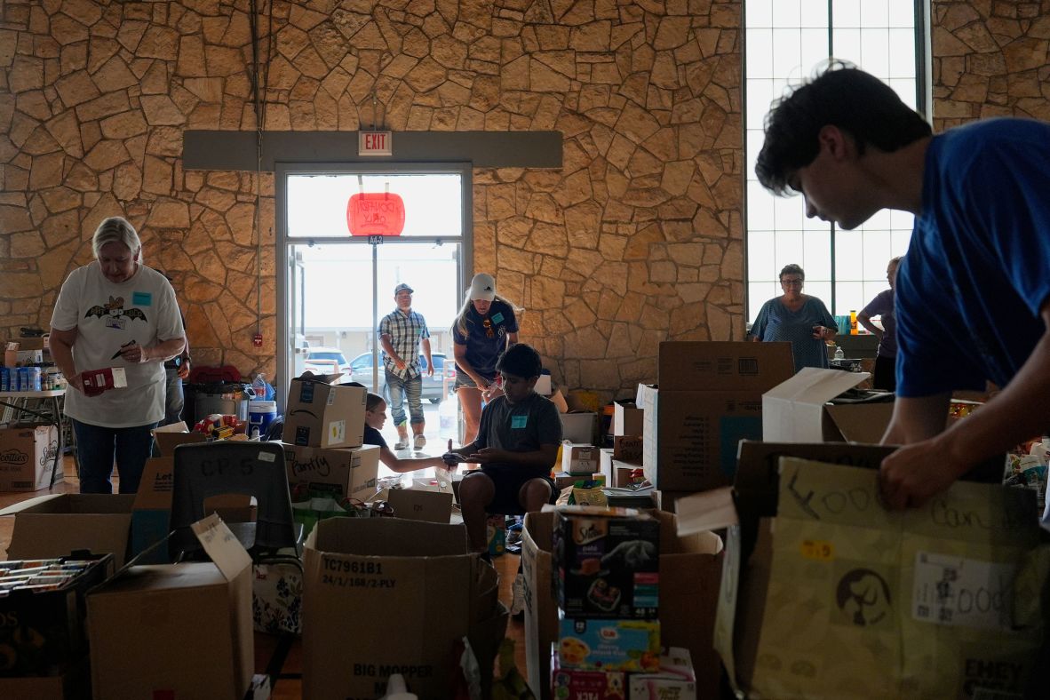 Volunteers sort donations at the Center Point Elementary School on Thursday, July 10.