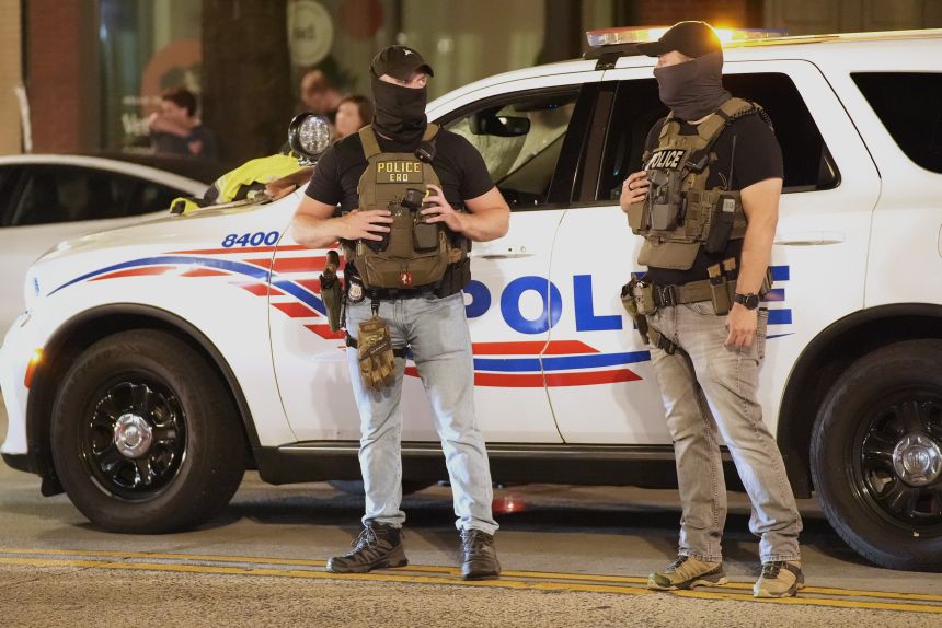 Department of Homeland Security Investigations agents join Washington Metropolitan Police Department officers as they conduct traffic checks at a checkpoint along 14th Street in northwest Washington, Wednesday, in Washington.