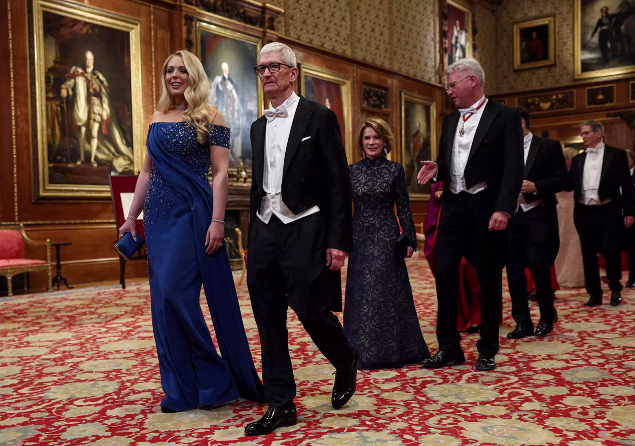Apple CEO Tim Cook, front, with Tiffany Trump, arrives for the banquet.
