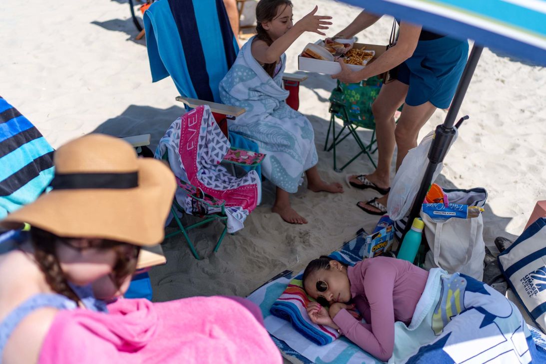 Ruth Wilson takes a nap after the onset of a migraine and fatigue, as too much sunshine is one of her triggers, while at the beach with family in South Yarmouth, Massachusetts.