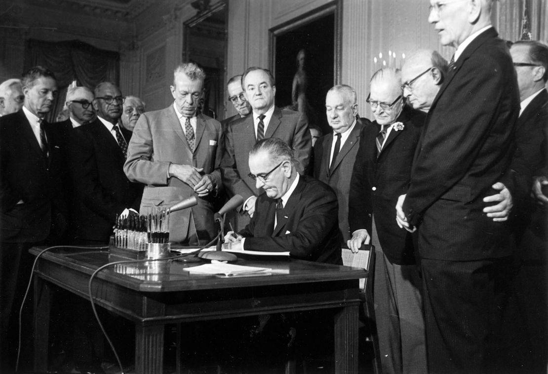 President Lyndon Baines Johnson signs the Civil Rights Act on July 2, 1964. The law made it illegal to discriminate on the basis of race, color, religion, sex, or national origin, and barred unequal application of voter registration requirements.