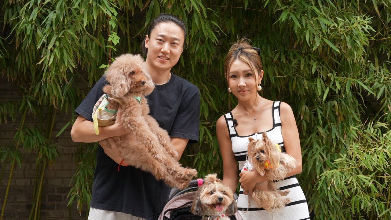 Hansen, left, and his wife Momo pose for a photo with their dogs in Beijing.