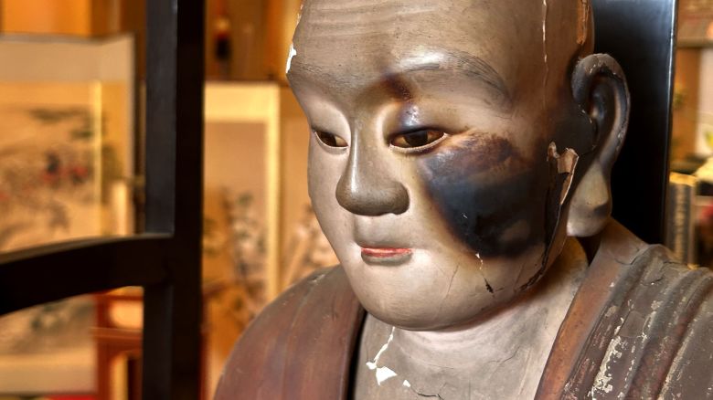 A statue of a revered Buddhist monk shows damage on its left side from the Aug. 14-15 firebombing of Kumagaya, Japan.

Brad Lendon/CNN
