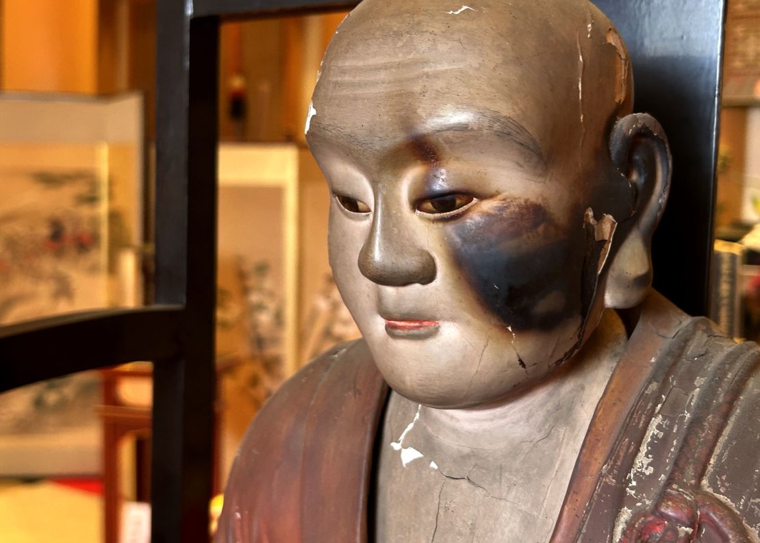 A statue of a revered Buddhist monk shows damage on its left side from the firebombing of Kumagaya, Japan.