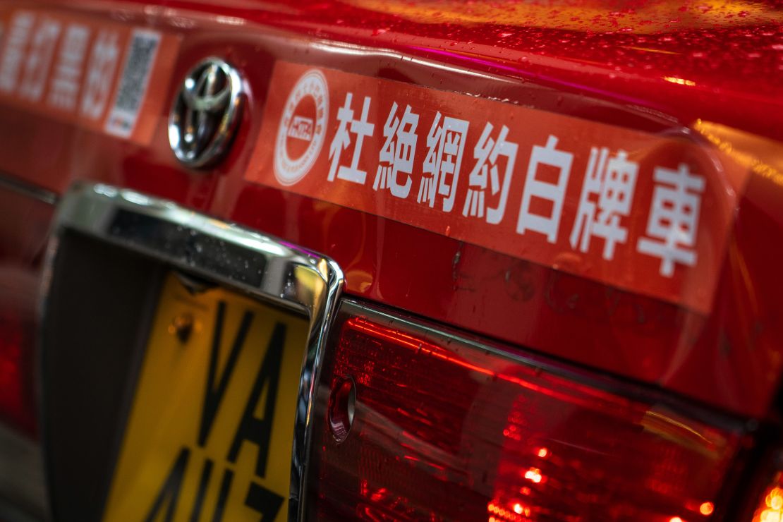 A sticker reading "Eliminate online booking of white-plate vehicles" is seen on the back of a taxi in Hong Kong, China, on May 24, 2024.