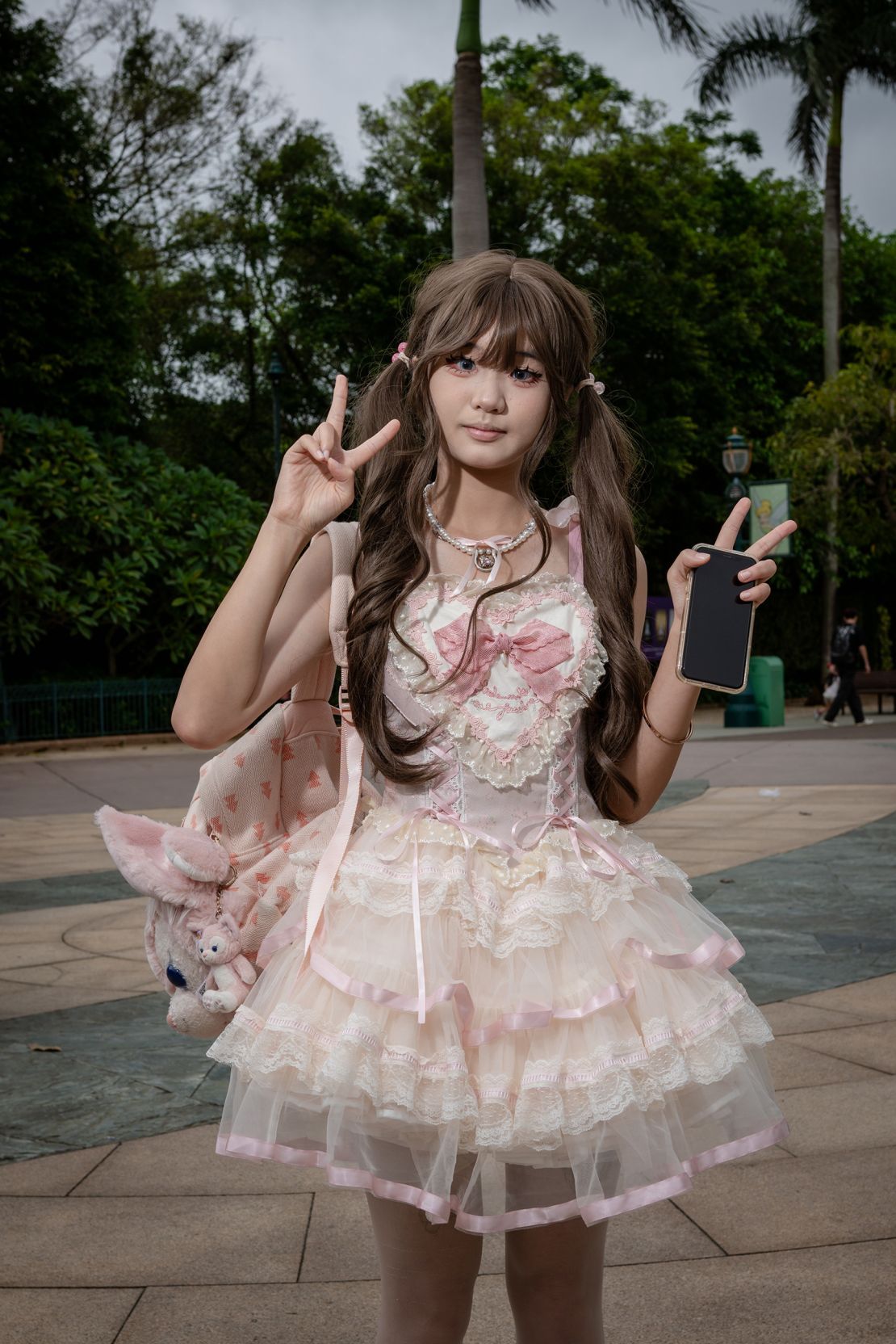 Hair carefully coiffed, and in full makeup Liang Xiaoyu, 18, is dressed for a day out at Hong Kong Disneyland. She was on her way to meet a friend.