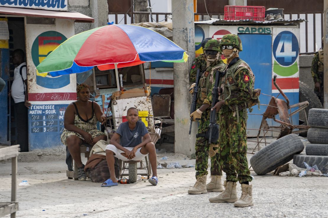 Kenyan police and Haitian civilians on the street in Port-au-Prince.