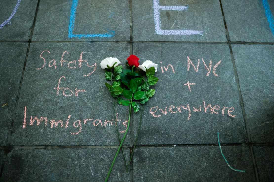 Flowers are seen on the ground during the "Protect Asylum Seekers" vigil in New York on February 1, 2024, following the death of a 3-month-old inside a Queens migrant shelter.